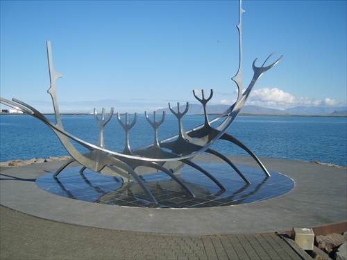 Socha vikingskej lode v Reykjavíku. Voda je zátoka Atlantického